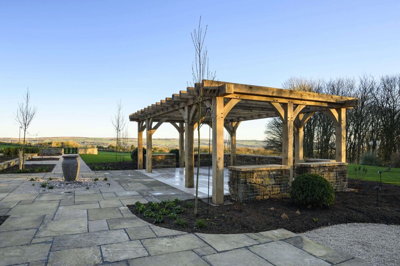 A large wooden pergola in a garden