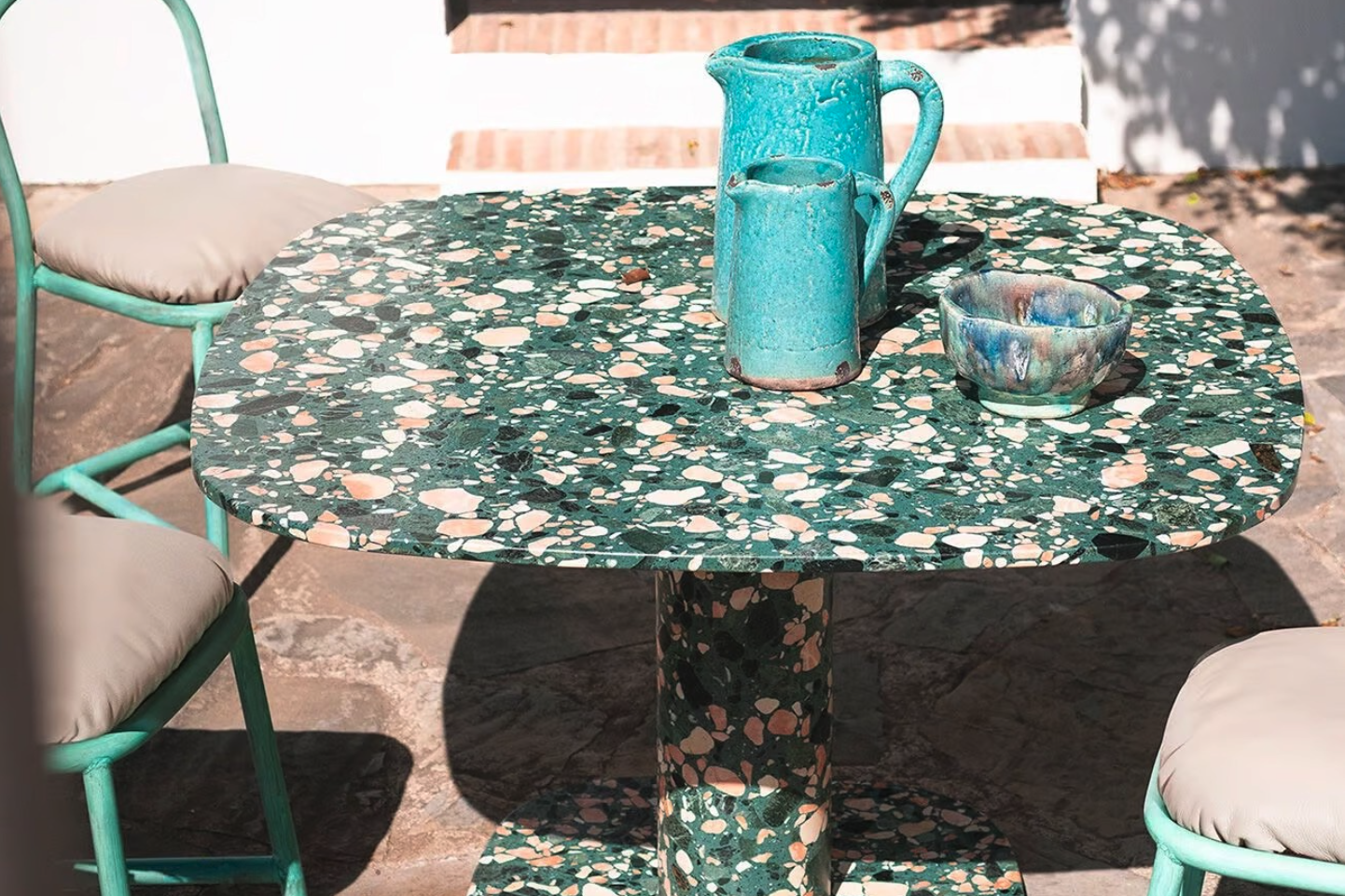 Baxter Matera Marble garden table with chairs and crockery on a patio