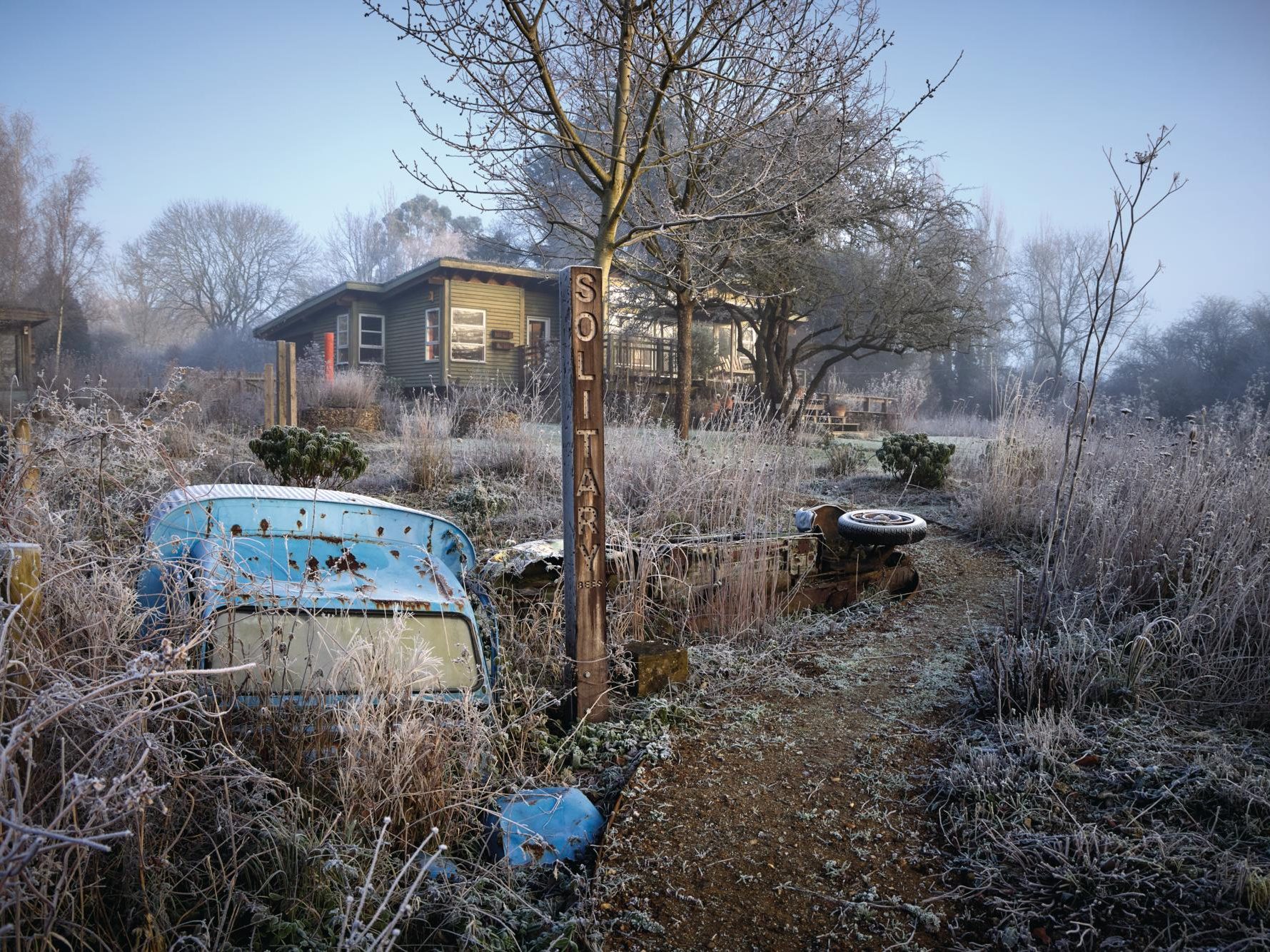 House and garden with disused car
