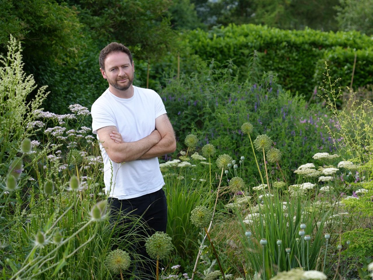 Jack Wallington standing in a garden